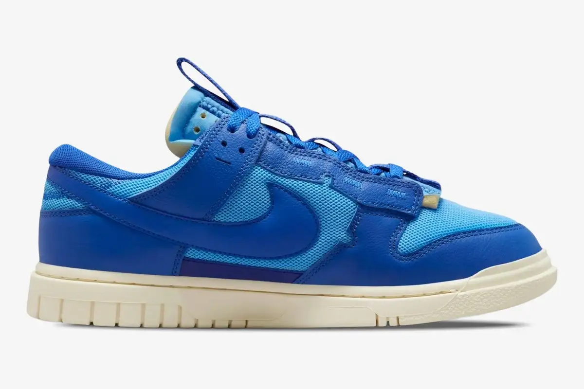 nike-dunk-low-remastered-jumbo-blue-side-view-dv0821-400 Nike Dunk Low Remastered Jumbo Blue sneaker in a side profile view featuring various shades of blue. - SKU DV0821-400