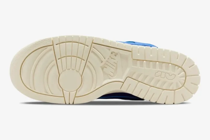 Bottom view of the off-white outsole on a Nike Dunk Low Remastered Jumbo Blue sneaker. - SKU DV0821-400