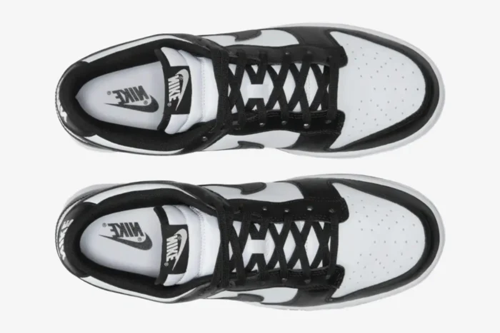 Top-down view of Nike Dunk Low Retro White Black Panda sneakers with black laces and white leather uppers. - SKU DD1391-100