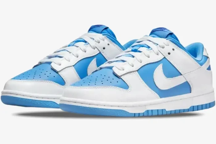 Three-quarter view of Nike Dunk Low Reverse University Blue sneakers with white overlays and blue base. - SKU DJ9955-101