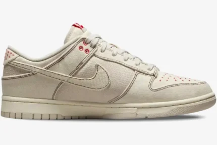 Nike Dunk Low SE Sashiko Light Orewood Brown sneaker in a side profile view with red stitching details. - SKU DV0834-100