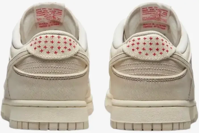 Rear view of Nike Dunk Low SE Sashiko Light Orewood Brown sneakers featuring red cross-stitching on the heel. - SKU DV0834-100