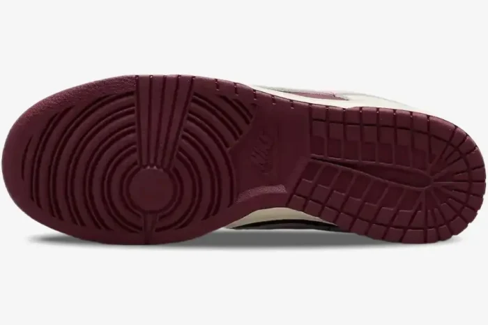 Bottom view of the Nike Dunk Low Premium Valentine's Day shoe showing the maroon rubber outsole traction pattern. - SKU DR9705-200