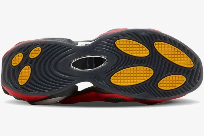 Bottom view of the Nike Glide x NOCTA Red Black outsole featuring yellow pods and black traction patterns. - SKU DM0879-600