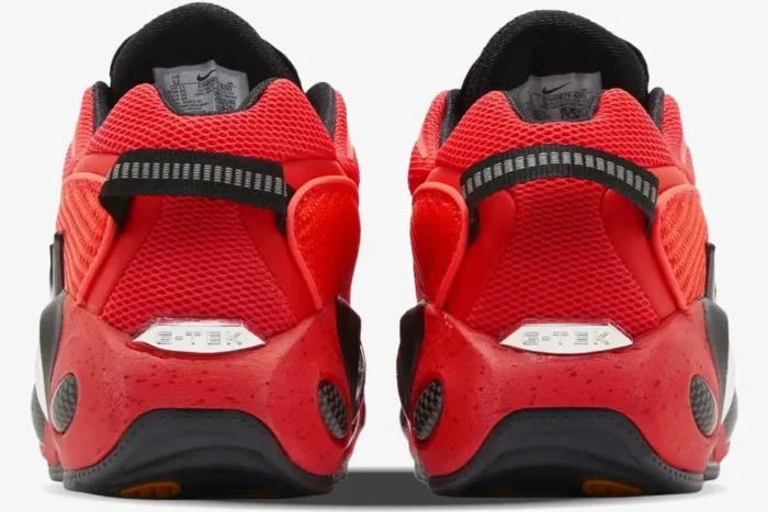 Rear view of red and black Nike Glide x NOCTA sneakers featuring silver G-TEK heel branding and mesh uppers. - SKU DM0879-600