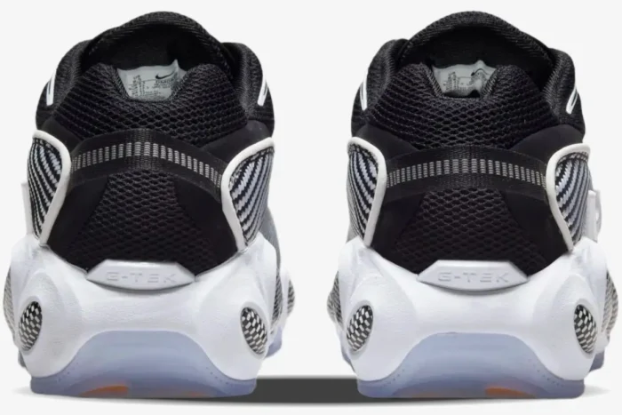 Rear view of Nike NOCTA Glide sneakers in black and white featuring G-TEK heel branding. - SKU DM0879-001