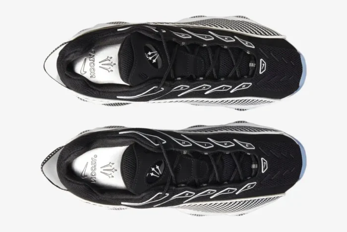 Top-down view of Nike NOCTA Glide sneakers in black and white with silver insoles. - SKU DM0879-001