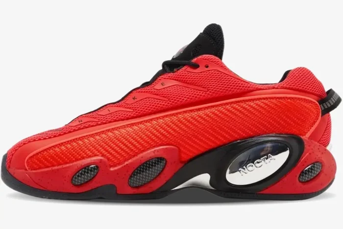 Side profile of the Nike Glide x NOCTA Red Black sneaker with mesh upper and chrome branding pod. - SKU DM0879-600