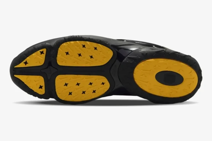 Bottom view of Nike Hot Step 2 x NOCTA Black sneaker showing yellow and black patterned outsole. - SKU DZ7293-001