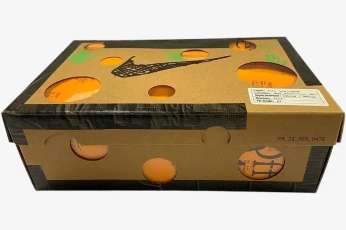 Nike Dunk Low x Off-White Lot 2 of 50 brown cardboard shoebox with circular cutouts and black graphics, angled view. - SKU DM1602115