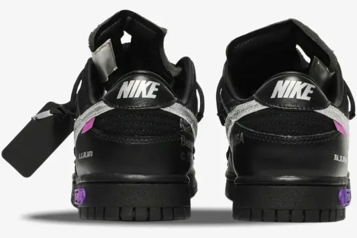 Rear view of black Nike Dunk Low x Off-White Lot 50 sneakers with silver swoosh and purple accents. - SKU DM1602-001