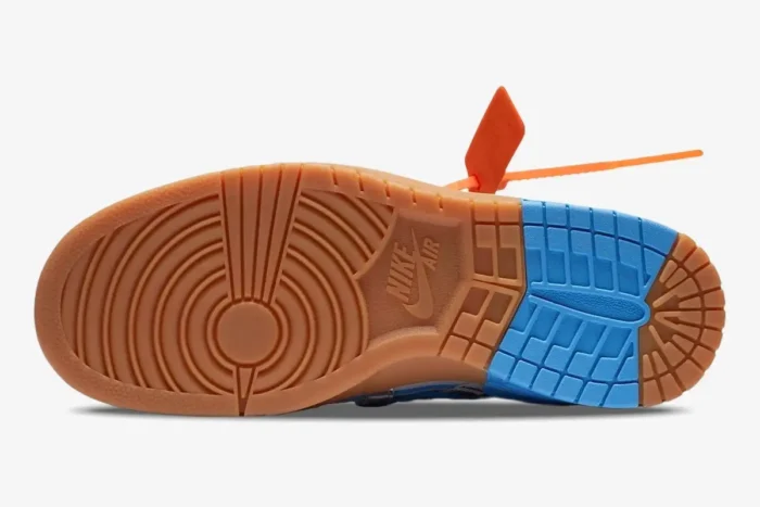 Bottom view of Nike Air Rubber Dunk x Off-White University Blue gum and blue outsole with orange zip tie. - SKU CU6015-100