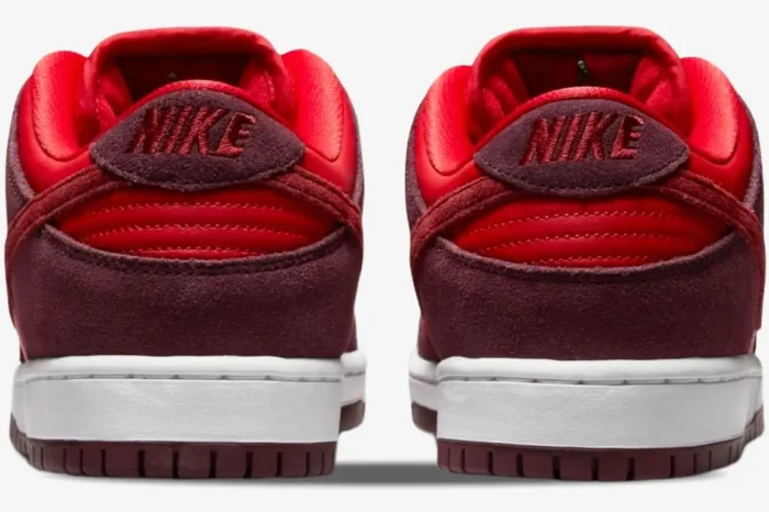 Rear view of Nike SB Dunk Low Cherry sneakers featuring burgundy suede and red leather details. - SKU DM0807-600