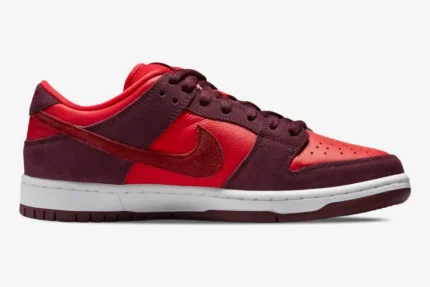 Side profile of Nike SB Dunk Low Cherry Fruit Pack sneakers in bright red and deep burgundy suede. - SKU DM0807-600