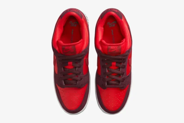 Top-down view of Nike SB Dunk Low Cherry sneakers in red and burgundy with suede overlays. - SKU DM0807-600