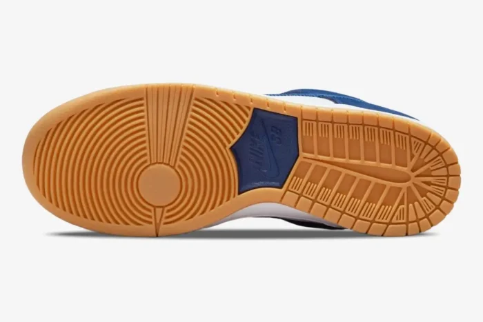 Bottom view of Nike SB Dunk Low LA Dodgers showing the gum rubber outsole and blue logo. - SKU DO9394-100