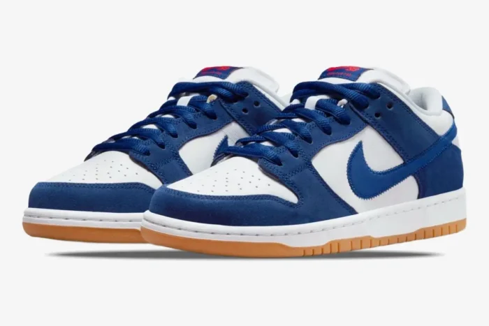Nike SB Dunk Low LA Dodgers sneakers in blue and white with gum soles, three-quarter front view. - SKU DO9394-100