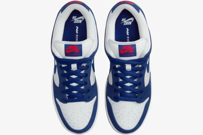Top-down view of Nike SB Dunk Low LA Dodgers sneakers in blue and white with red accents. - SKU DO9394-100