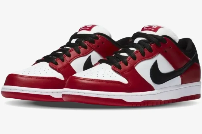 Nike SB Dunk Low Pro Chicago J-Pack sneakers in red, white, and black, three-quarter front view. - SKU BQ6817-600