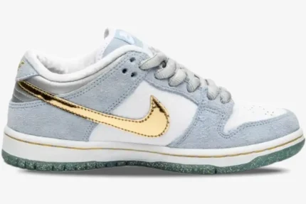 Side view of Nike SB Dunk Low Sean Cliver in light blue and white with a metallic gold swoosh. - SKU DC9936-100