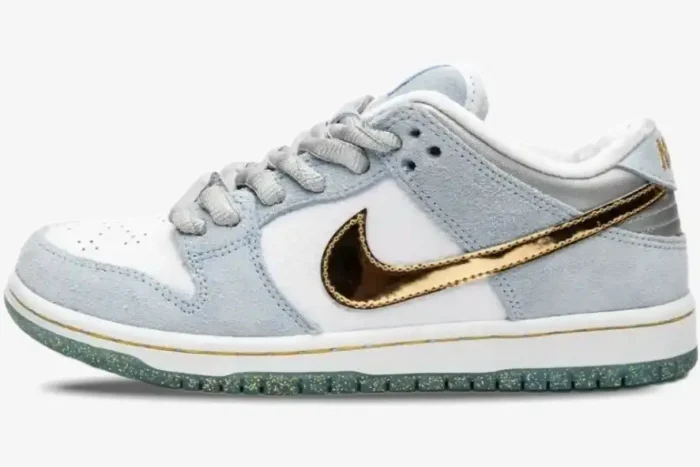 Nike SB Dunk Low x Sean Cliver Holiday Special in light blue and white with a metallic gold Swoosh, side view. - SKU DC9936-100