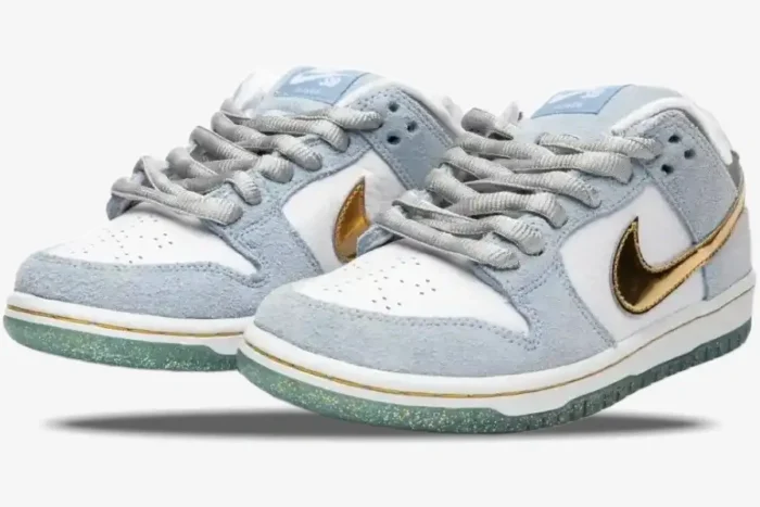 Nike SB Dunk Low x Sean Cliver Holiday Special sneakers in light blue and white, three-quarter front view. - SKU DC9936-100