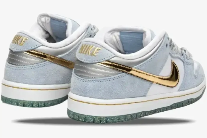 Nike SB Dunk Low Sean Cliver in light blue and white, rear three-quarter view showing gold swoosh. - SKU DC9936-100