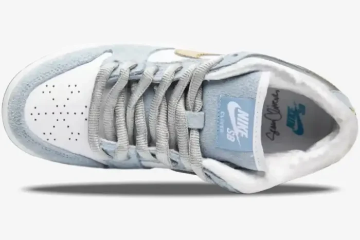 Top-down view of Nike SB Dunk Low Sean Cliver in light blue and white with snowflake toe perforations. - SKU DC9936-100