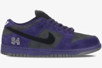 Side view of Nike SB Dunk Low x Supreme purple and grey suede sneakers with black swoosh and 94 embroidery. - SKU HQ8487500