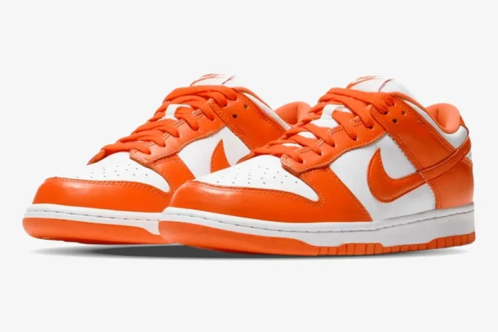Nike SB Dunk Low Syracuse sneakers in orange and white, shown from a front-side angle. - SKU CU1726-101