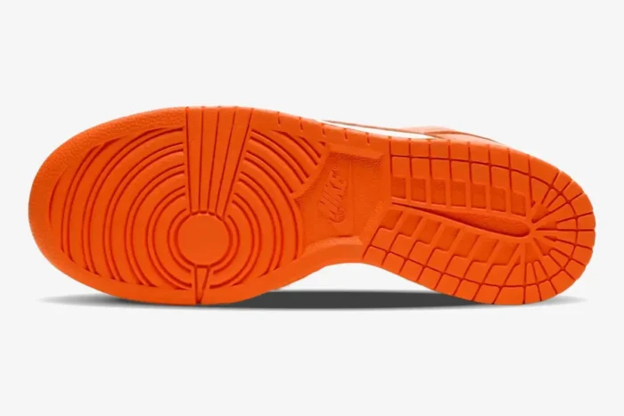 Bottom view of the Nike SB Dunk Low Syracuse showing the bright orange rubber outsole traction pattern. - SKU CU1726-101