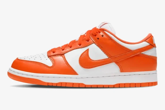 Side profile of Nike SB Dunk Low Syracuse sneakers in vibrant orange and white leather. - SKU CU1726-101