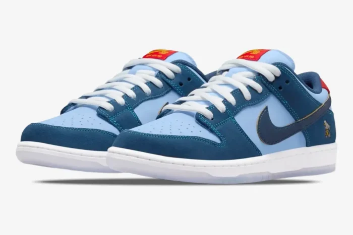 Nike SB Dunk Low x Why So Sad? The Predatory Bird blue sneakers, three-quarter front view on white background. - SKU DX5549-400