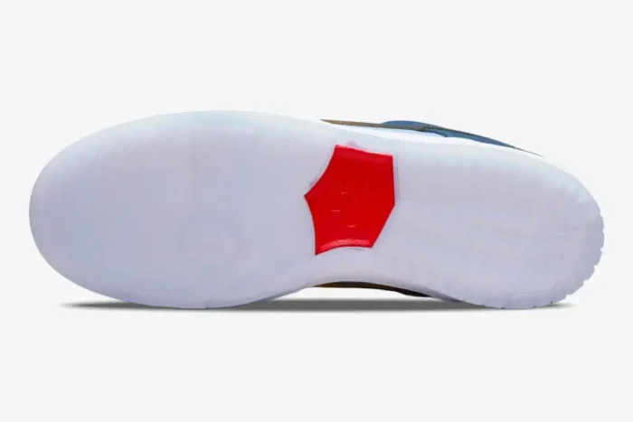 Bottom view of Nike SB Dunk Low x Why So Sad? with a translucent icy blue outsole and red center logo. - SKU DX5549-400