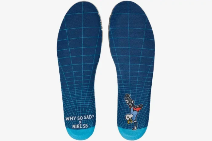 Top-down view of blue grid insoles for Nike SB Dunk Low x Why So Sad? with graphic and text details. - SKU DX5549-400