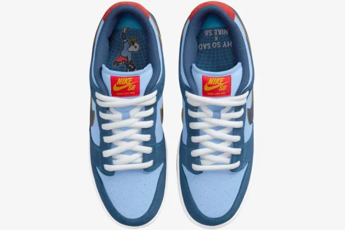 Top-down view of Nike SB Dunk Low x Why So Sad? sneakers in blue and red with white laces. - SKU DX5549-400