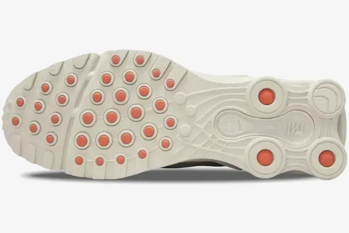 Bottom view of Nike Shox Ride 2 Cream Orange sneakers showing the textured outsole and orange traction pods. - SKU DJ5415-100