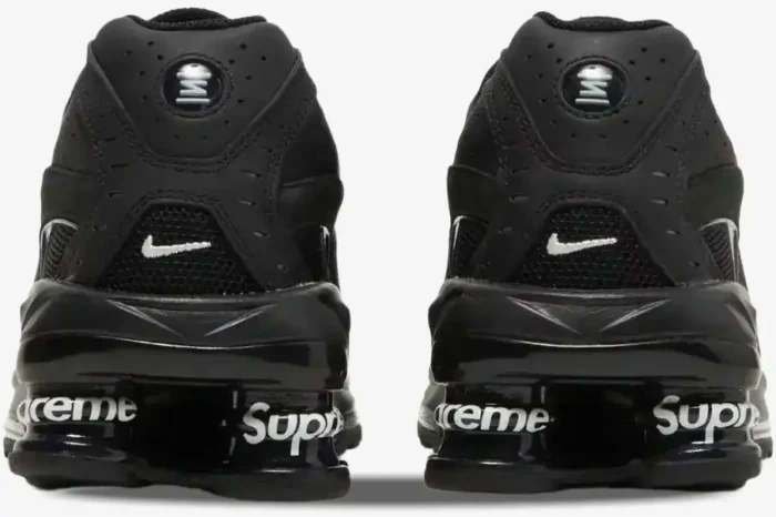 Rear view of black Nike Shox Ride 2 x Supreme sneakers featuring white Supreme branding on the heel pillars. - SKU DN1615-001