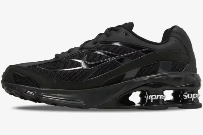 Side profile of the all-black Nike Shox Ride 2 x Supreme sneaker with white Supreme branding on the heel pillars. - SKU DN1615-001