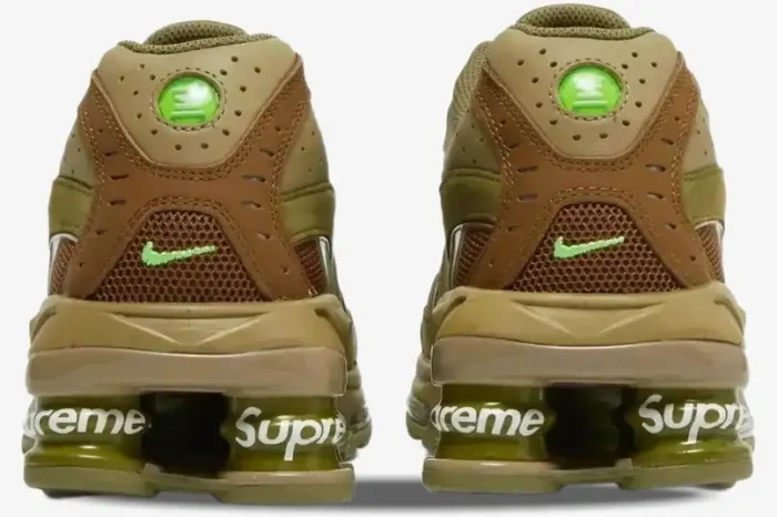 Rear view of Nike Shox Ride 2 x Supreme sneakers in neutral olive with white Supreme branding on the Shox pillars. - SKU DN1615-200
