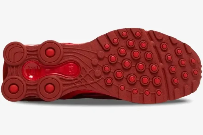 Bottom view of the all-red Nike Shox Ride 2 x Supreme sneaker outsole showing traction patterns and heel pillars. - SKU DN1615-600