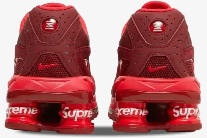 Rear view of red Nike Shox Ride 2 x Supreme sneakers featuring white Supreme branding on the heel pillars. - SKU DN1615-600