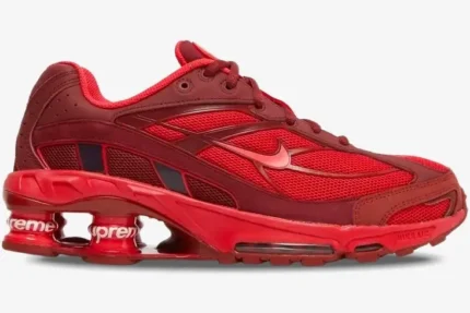 Side profile of Nike Shox Ride 2 x Supreme sneakers in red with mesh upper and branded Shox columns. - SKU DN1615-600