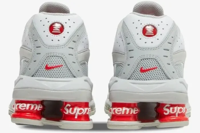 Rear view of Nike Shox Ride 2 x Supreme sneakers in white and red with branded pillars. - SKU DN1615-100