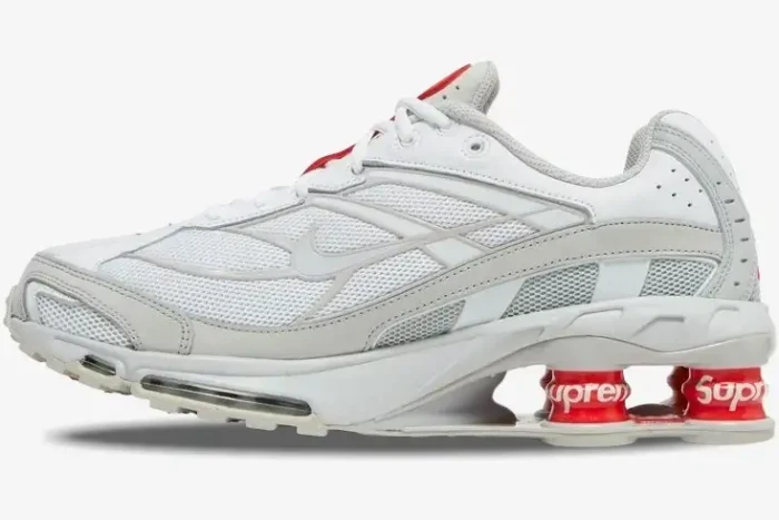 Nike Shox Ride 2 x Supreme sneaker in white and red, side profile view showing red Shox pillars. - SKU DN1615-100