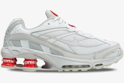 Side profile of Nike Shox Ride 2 x Supreme sneakers in white with red Shox pillars and branding. - SKU DN1615-100