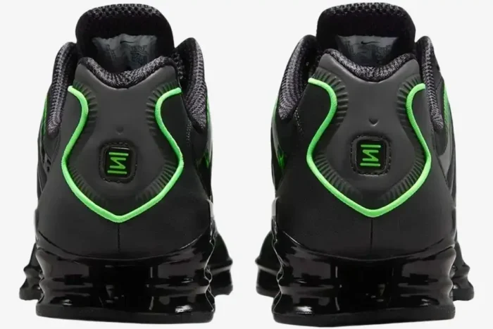 Rear view of Nike Shox TL Black Green Strike sneakers showing the heel logo and black Shox columns. - SKU AV3595-012