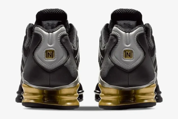 Rear view of Nike Shox TL x Neymar Jr. sneakers in black and gold, featuring gold Shox columns and N logo. - SKU BV1388-001