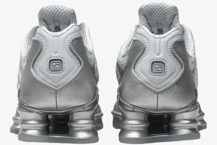 Rear view of Nike Shox TL Pure Platinum Chrome sneakers showing metallic silver heel columns and logos. - SKU AV3595-003
