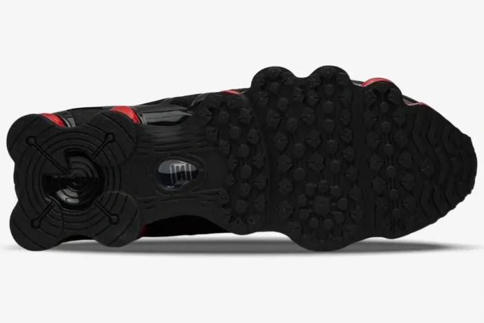 Bottom view of the black and red Nike Shox TL x Skepta sneaker showing the textured rubber outsole. - SKU CI0987-001
